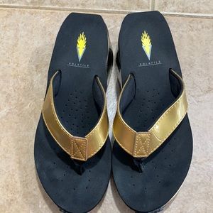 Volatile gold and black sandals